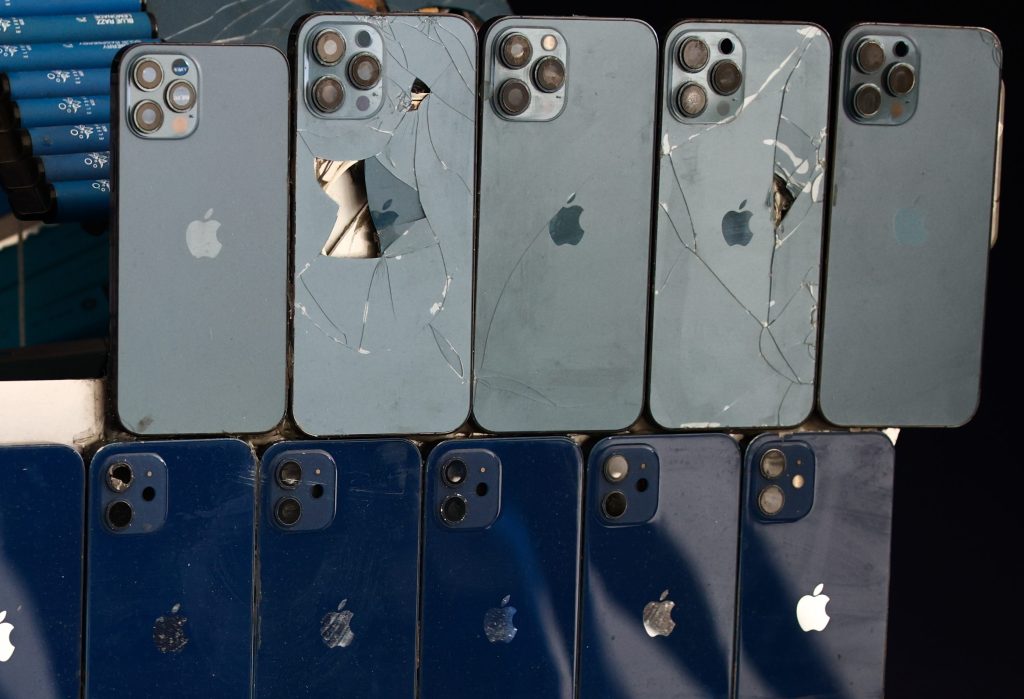 Broken iPhones are seen as a part of replica of Formula E car made by used electronics, on the opening day of the United Nations Climate Change Conference COP28 in Dubai, United Arab Emirates on November 30, 2023.