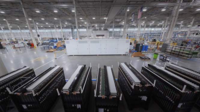 A big battery sits inside a factory.