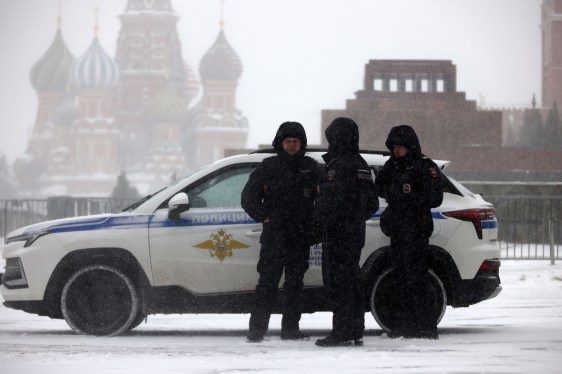 Russian Police officers walk during a snowstorm at Red Square, on February 16, 2026, in Moscow, Russia.
