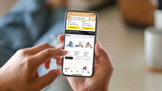 person holding mobile phone with Shop Direct on screen