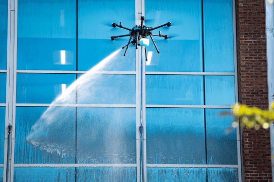 Image of a Lucid Bots drone cleaning a building.
